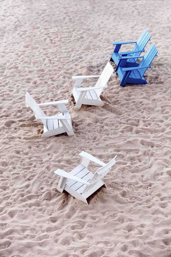Blue and White Plastic Deck Chairs on the Sands of a Beach Stock Photo