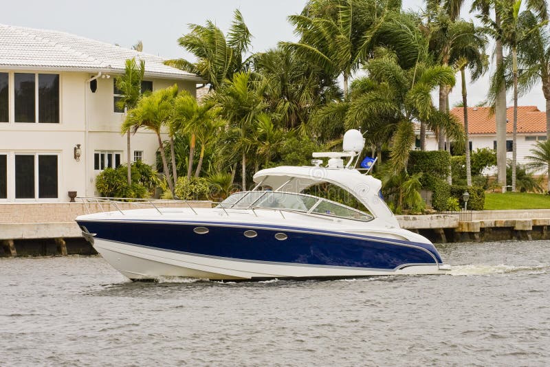 Blue and White Yacht in Canal