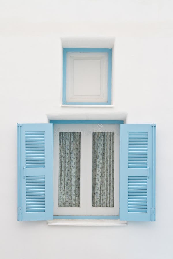 Blue window on white house stock photo