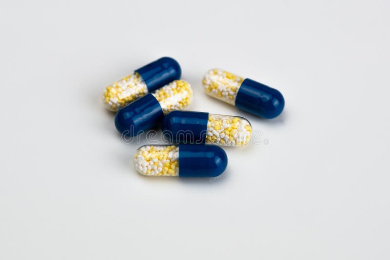Blue and Yellow Capsules on Light Grey Background Stock Image Image