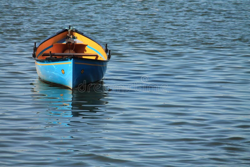 Blue yellow kayak canoe parked in harbor isolated stock photo
