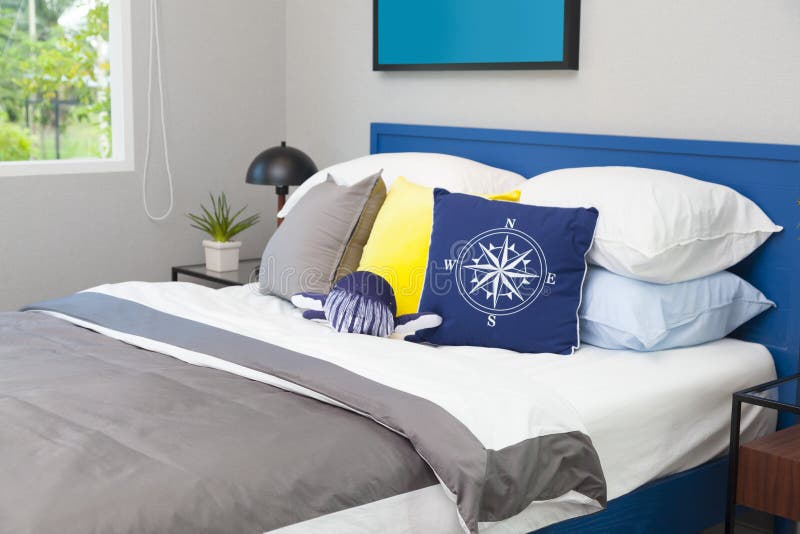 Blue and yellow pillow on teen`s bedroom
