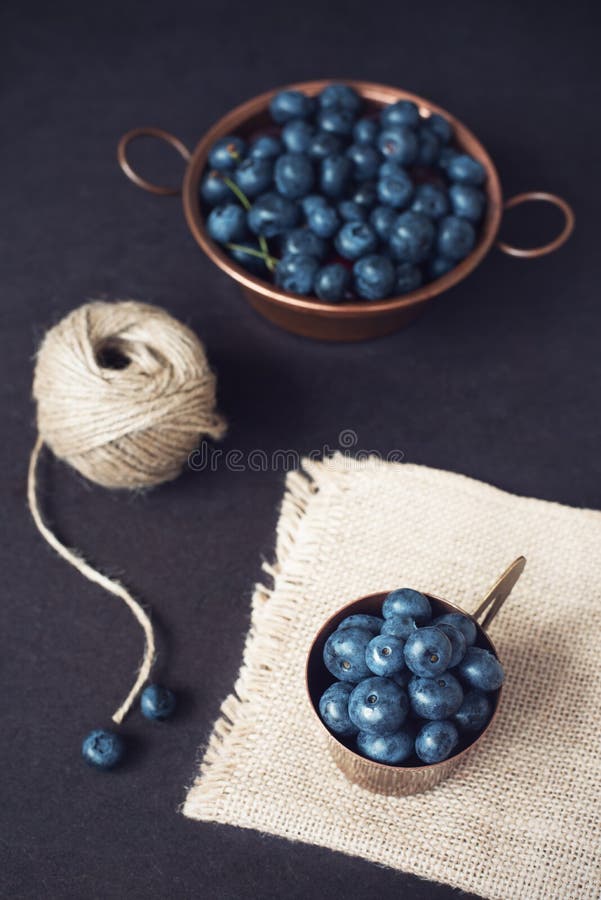 Blueberries dark picture. Fresh fruits, berries in an old copper cup. Dark Styled Stock Photo, Black Background royalty free stock images Blueberries dark picture. Fresh fruits, berries in an old copper cup. Dark Styled Stock Photo, Black Background royalty free stock images