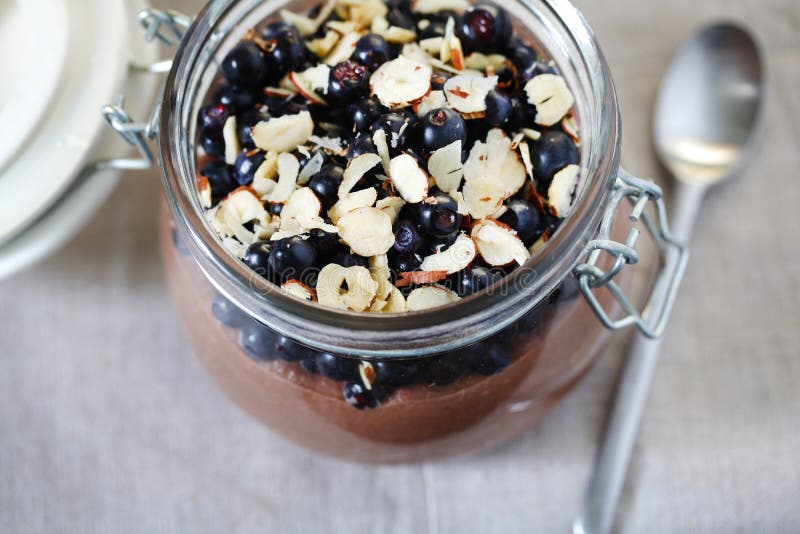 Blueberries with hazelnuts with chocolate pudding in a jar