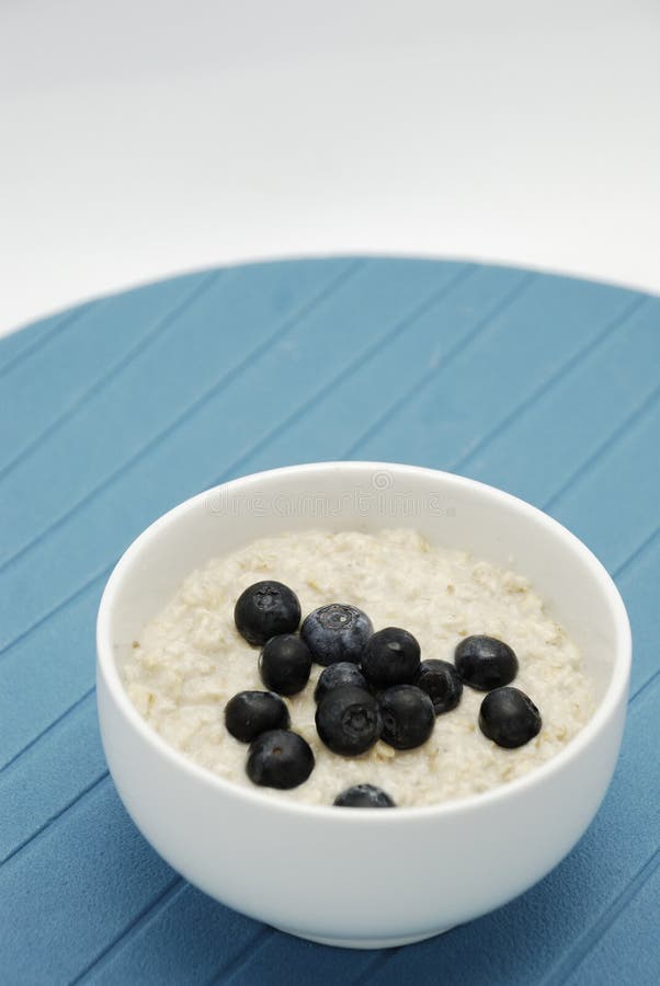 Blueberries and oatmeal in white bowl