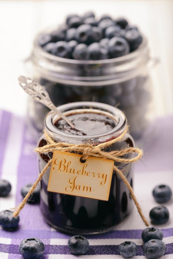 Blueberry Jam in Glass Jars and Blueberries. Selective Focus. Stock