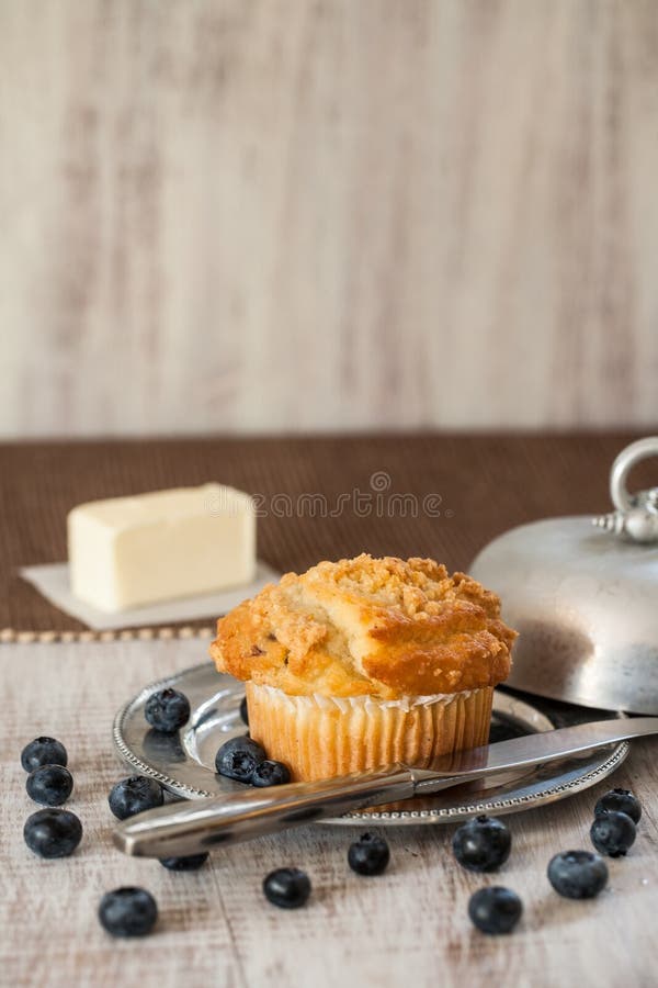 Blueberry Muffin with Blueberries and Butter and Knife Stock Photo
