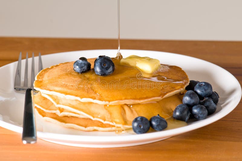 Blueberry pancakes on a plate with fork