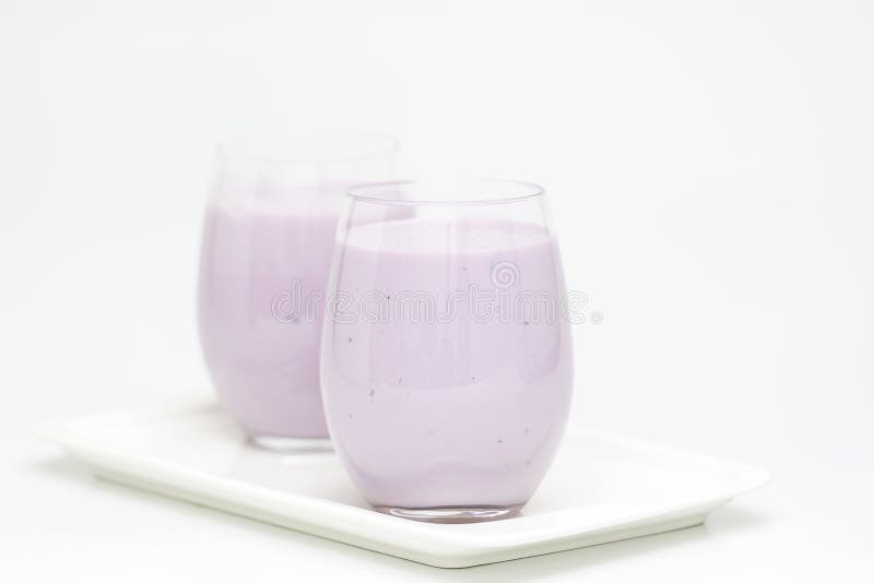 Blueberry smoothie with fresh blueberries on light background. Healthy summer drink. Vegetarian dessert.