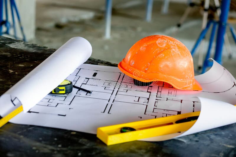 Blueprints Project Building, Construction Level and Helmet, Close Up. Construction Concept Stock