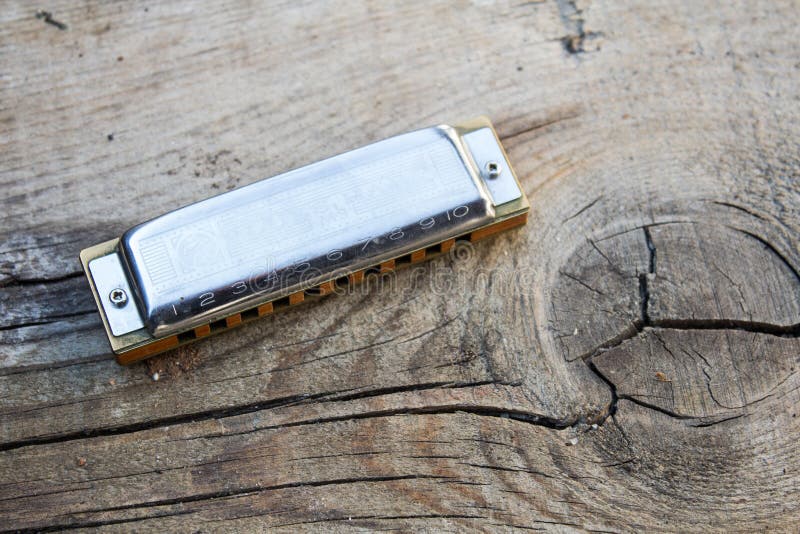 Blues harmonica music instrument on a old cracked wood background