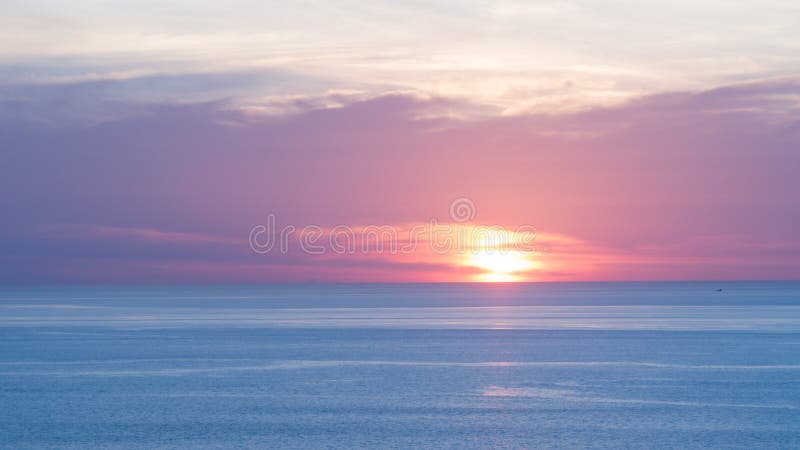 Blur beautiful soft blue and orange sky above the sea. Sunset in background. Abstract blue orange sky. Dramatic blue sky at the su
