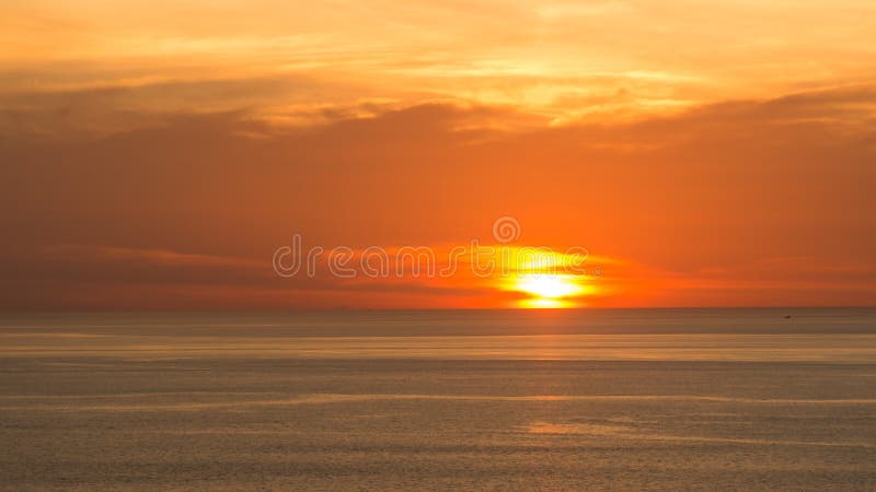 Blur beautiful soft orange sky above the sea. Sunset in background. Abstract orange sky. Dramatic golden sky at the sunset backgro