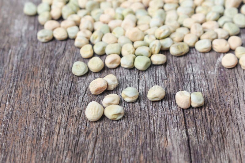 Dry Sugar Pea Seed, Green Nuts on the Wood Board Background Stock Photo