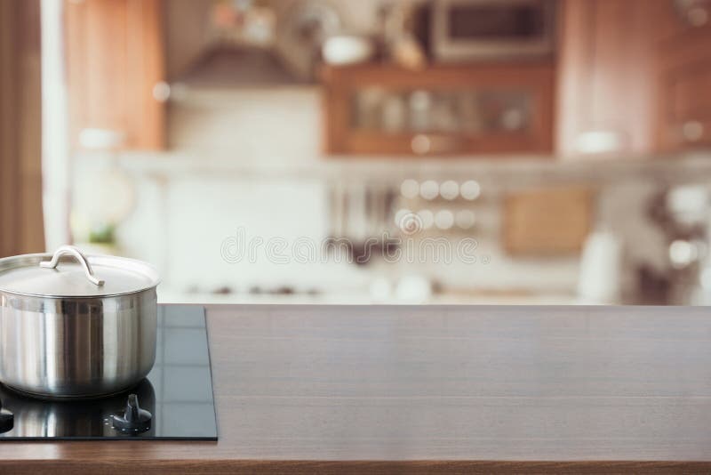 Blurred and Abstract Kitchen Background. Wooden Tabletop with Pan and