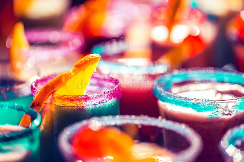 Blurred bright neon cocktail glasses background stock photo Blurred bright neon cocktail glasses background stock photo