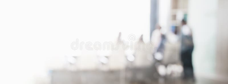 Blurred business people in office interior with space for background or banner design