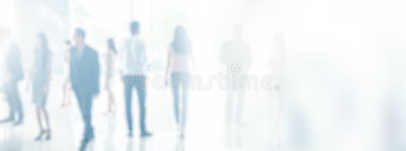 Blurred business people in office interior with space for background or banner design