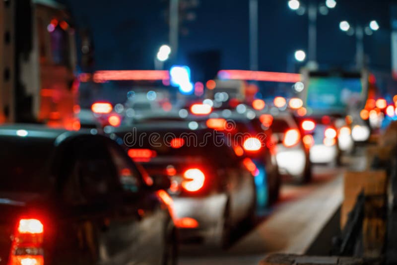 Blurred Car Traffic Light at Night City. Traffic Jam in Evening Rush