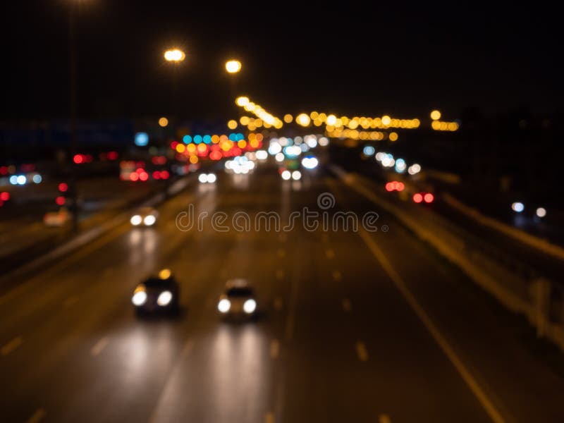 Blurred Cars Driving on a Motorway at Night. Seeing Bokeh Car ...