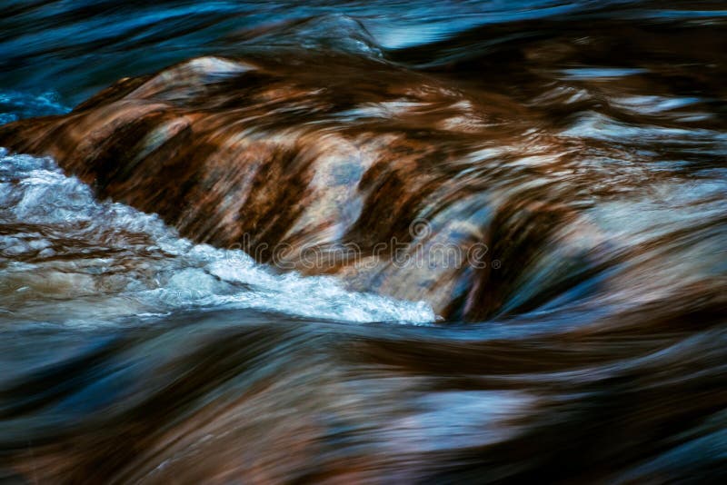 Blurred cascades on the autumn river