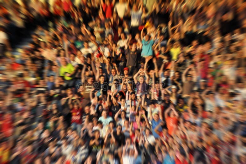 Blurred, defocused crowd of spectators on a stadium tribune