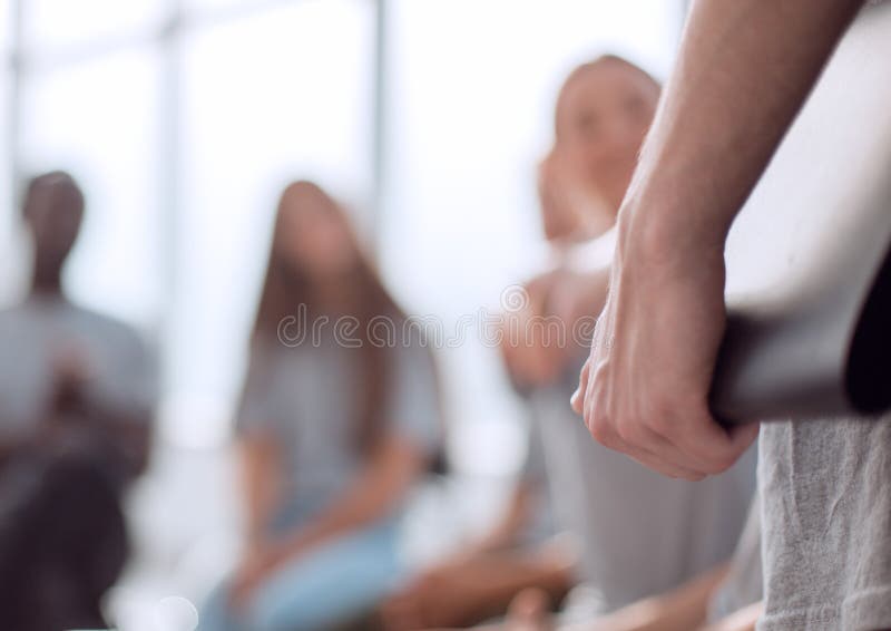 Blurred image of a group of young people sitting in a circle stock image