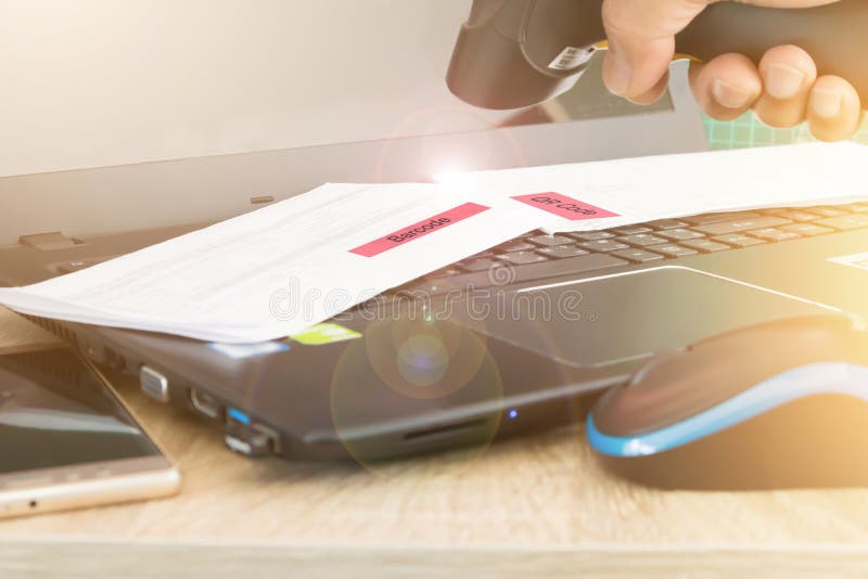 Blurred image hand holding barcode reader focus to barcode on paper. concept of computer and technology royalty free stock image