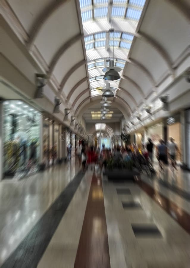 Blurred image of indoor mall gallery with fashion stores on both sides. stock photos Blurred image of indoor mall gallery with fashion stores on both sides. stock photos
