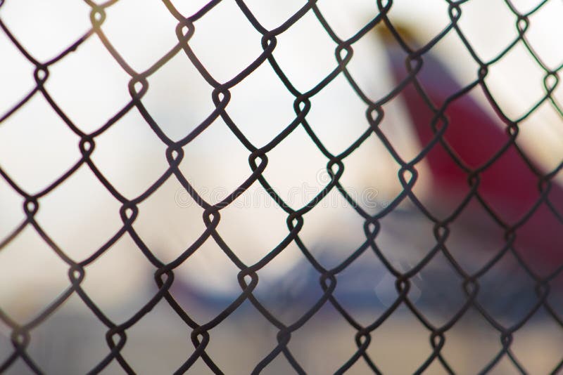 blurred-image-plane-parked-near-runway-seen-airport-security-fence-juan-santa-mar%C3%ADa-alajuela-costa-rica-213207494.jpg