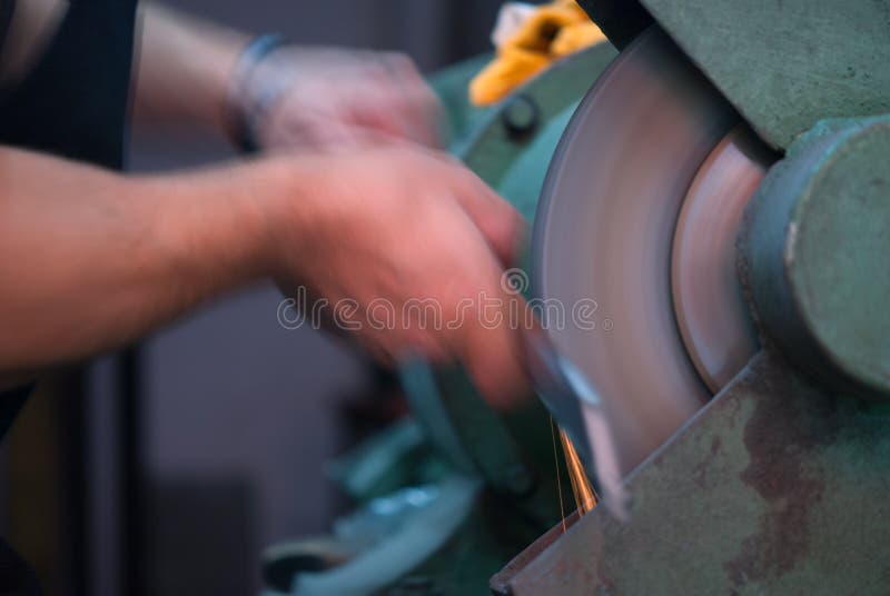 Blurred movement of blacksmith polishing royalty free stock photo