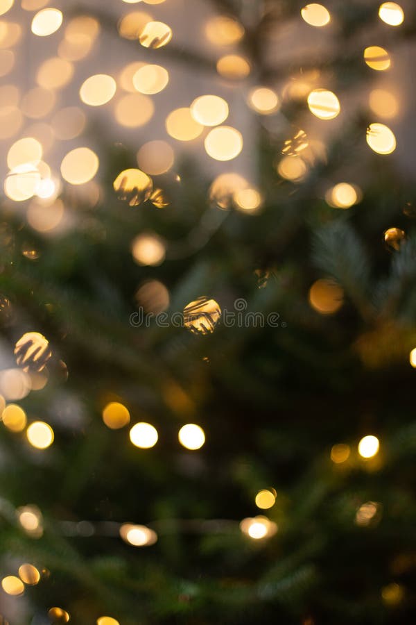 Blurred Photo of Christmas Tree Shining with Lights of Garland Stock