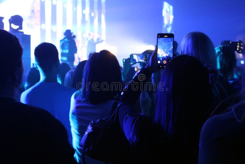 Blurred photo people at a concert stand and shoot on the phone royalty free stock photography Blurred photo people at a concert stand and shoot on the phone royalty free stock photography