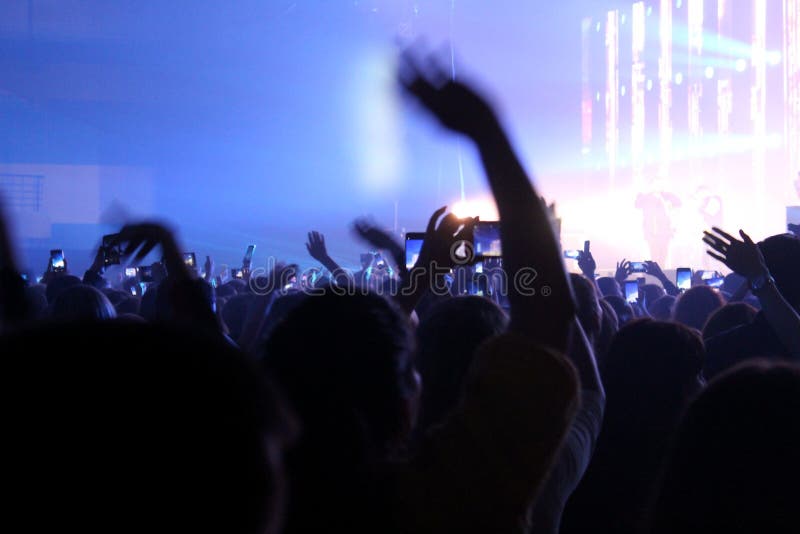 Blurred photo people at a concert stand and wave their hands royalty free stock image Blurred photo people at a concert stand and wave their hands royalty free stock image