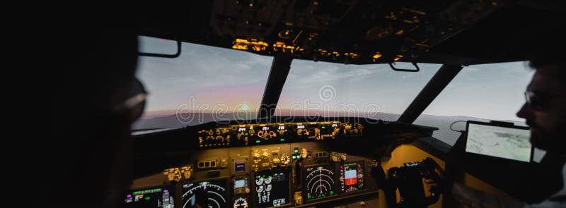 blurred professionals piloting airplane in evening