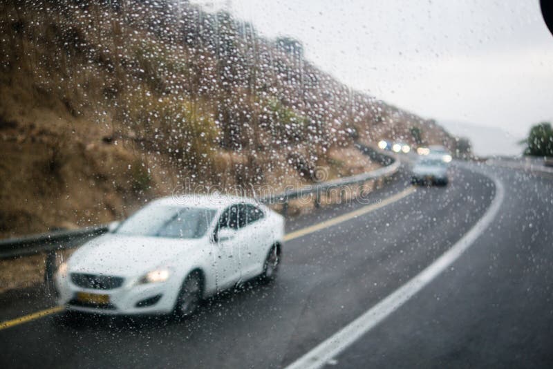 Blurred Street Scene through Car Windows with Rain Drop Stock Photo