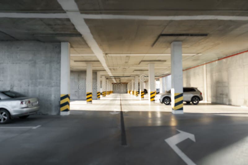 Blurred View of Open Parking Garage with Cars on Sunny Day Stock Photo