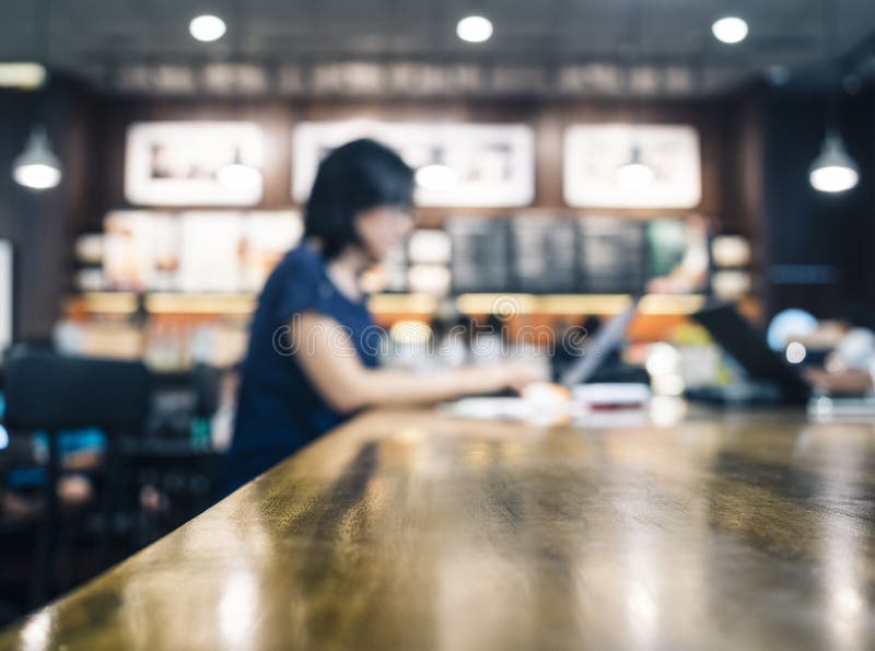 Blurred Woman working with laptop on table in cafe stock photos Blurred Woman working with laptop on table in cafe stock photos