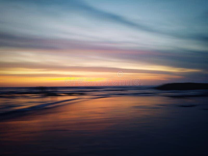 Blurry beach landscape background. Colorful sunset sunrise backgrounds. Dramatic sky colors over horizon. Blurry wave motion. royalty free stock images