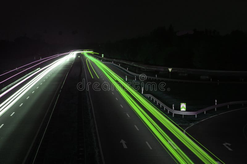 Road with car traffic at night and blurry lights showing speed and motion. Road with car traffic at night and blurry lights showing speed and motion