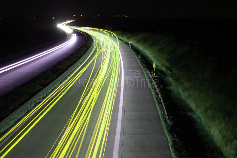 Road with car traffic at night and blurry lights showing speed and motion. Road with car traffic at night and blurry lights showing speed and motion