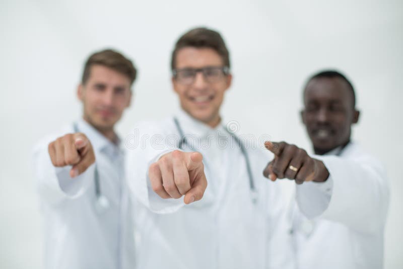 Blurry image of a group of doctors pointing at you royalty free stock image