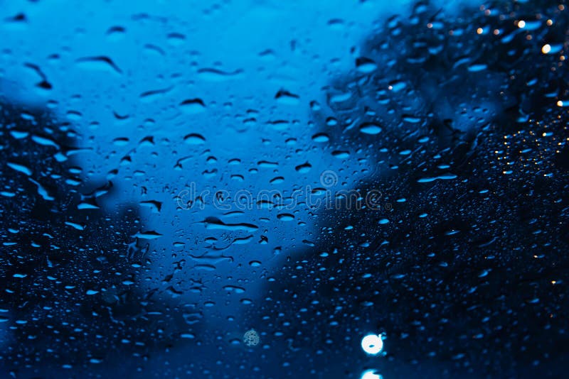 Blurry Rain Drops on Window Glasses Surface with Cloudy Background