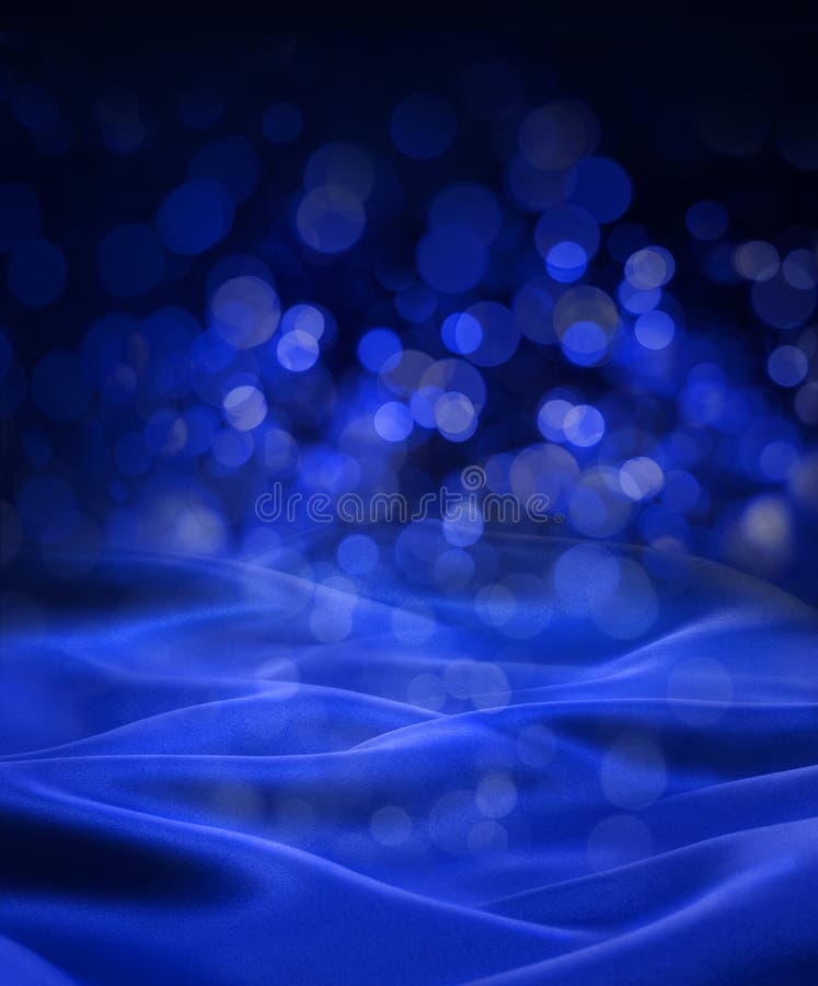 An abstract blue background with fairy lights and blue satin material. An abstract blue background with fairy lights and blue satin material