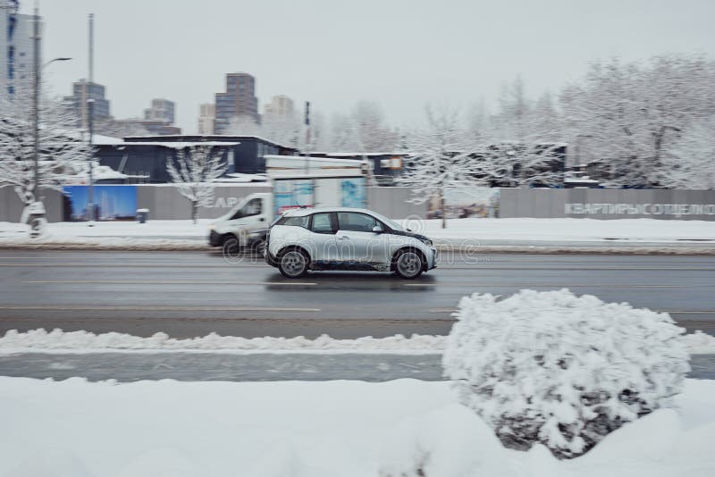 Moscow, Russia - January 2022: BMW i3 car fast speed driving on the asphalt road in winter