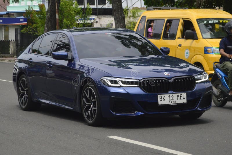 A blue sedan BMW 5 Series 520i M Sport 2023 on the streets in Medan, North Sumatra, Indonesia &#x28;Apr 3, 2024&#x29;.