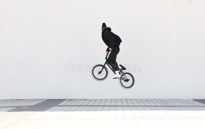 Bmx freestyle on the background of a white wall royalty free stock photography Bmx freestyle on the background of a white wall royalty free stock photography