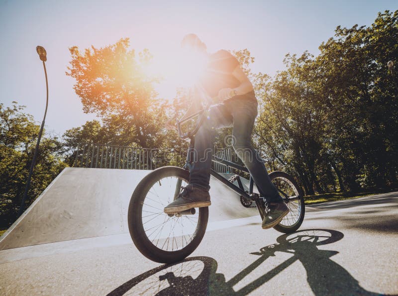 Bmx Rider Performing Tricks at Skatepark. Outdoors. Stock Photo Image