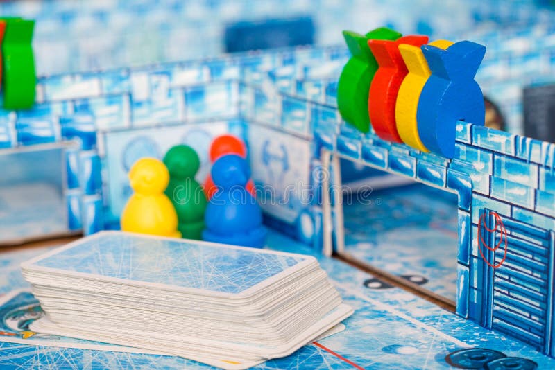Board game and kids leisure concept - red, yellow, blue, green wood chips figure and playing cards in children play. Board game and kids leisure concept - red stock images Board game and kids leisure concept - red, yellow, blue, green wood chips figure and playing cards in children play. Board game and kids leisure concept - red stock images