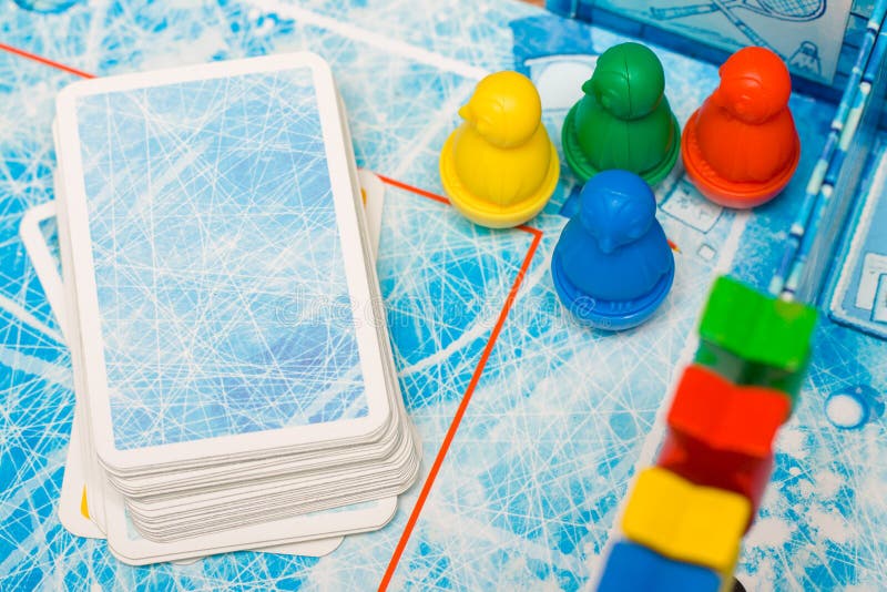 Board game and kids leisure concept - red, yellow, blue, green wood chips figure and playing cards in children play. Board game and kids leisure concept - red royalty free stock images Board game and kids leisure concept - red, yellow, blue, green wood chips figure and playing cards in children play. Board game and kids leisure concept - red royalty free stock images